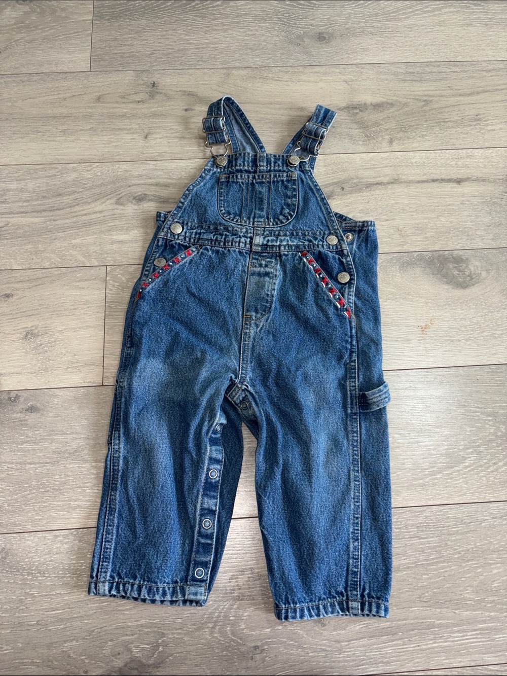 Faded Glory blue denim overalls with red trim